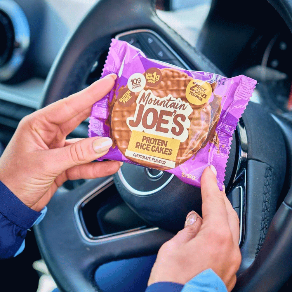 Lifestyle Shot in the car of Mountain Joe's Protein Rice Cakes