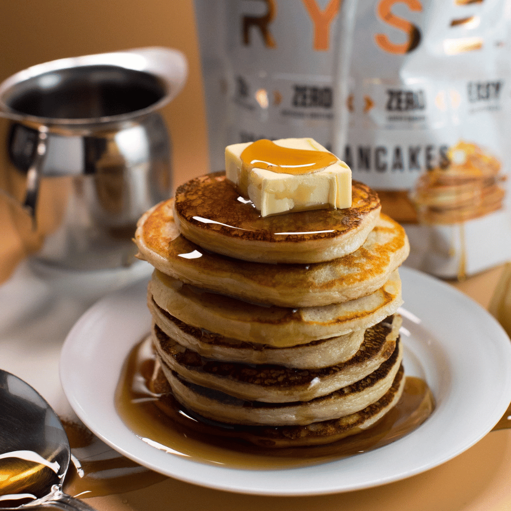 A stack of RYSE Loaded Protein Pancakes With Syrup